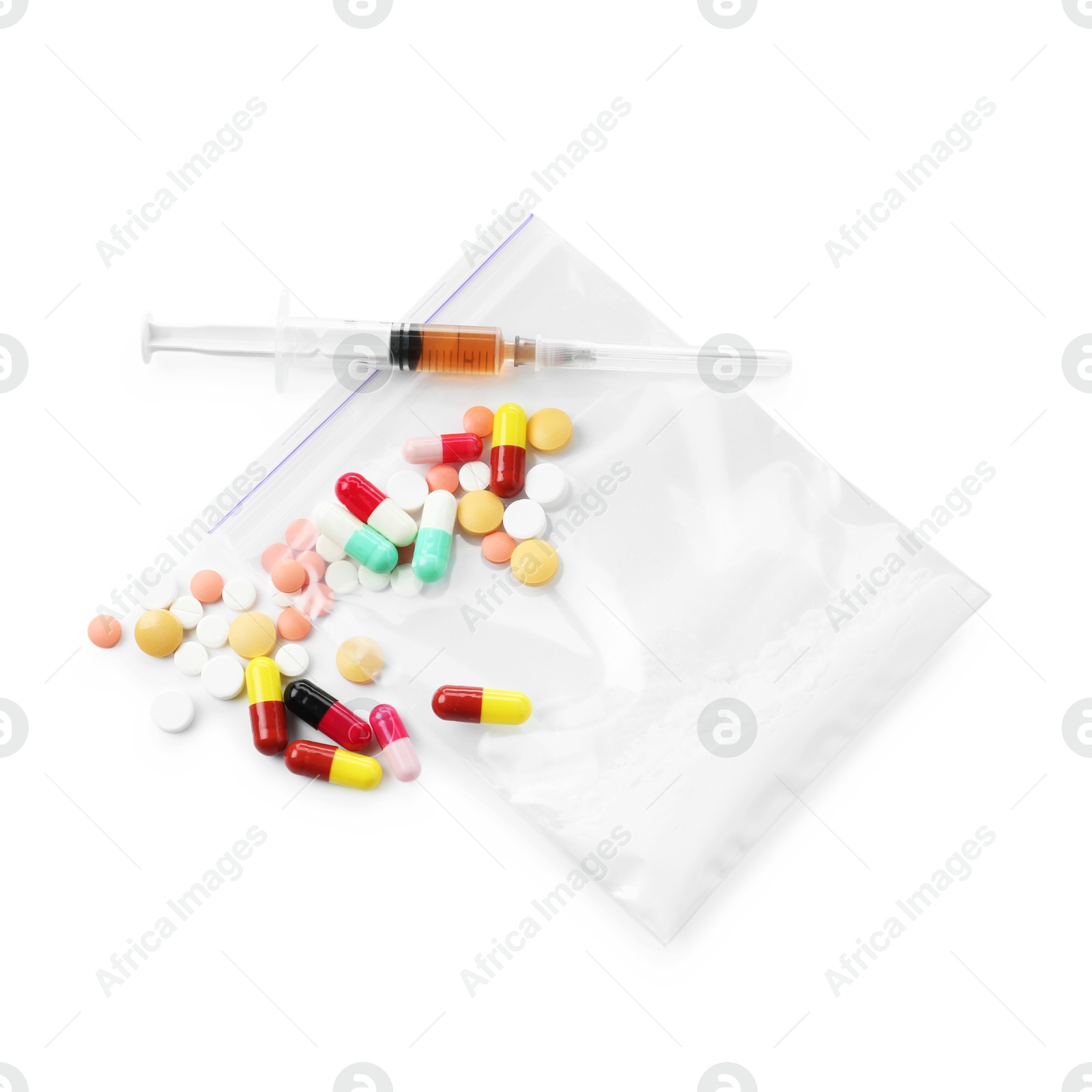 Photo of Drug addiction. Different pills, plastic bag with powder and syringe isolated on white, top view