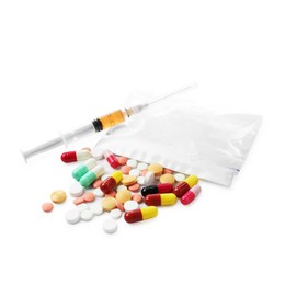 Photo of Drug addiction. Different pills, plastic bag with powder and syringe isolated on white