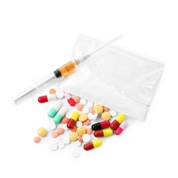 Photo of Drug addiction. Different pills, plastic bag with powder and syringe isolated on white, top view