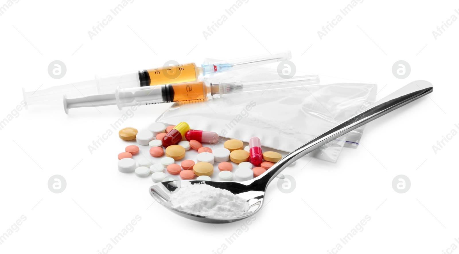 Photo of Drug addiction. Different pills, spoon with powder and syringes isolated on white