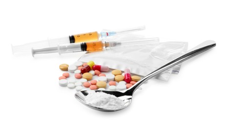 Photo of Drug addiction. Different pills, spoon with powder and syringes isolated on white