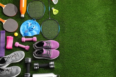 Photo of Different sport equipment on artificial grass, flat lay. Space for text