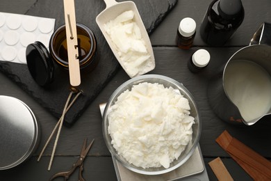 Photo of Soy wax, essential oils and different tools for making candles on grey wooden table, flat lay