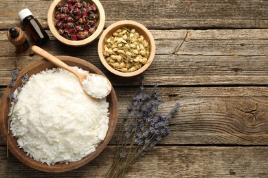 Photo of Soy wax in bowl and other different ingredients for making candles on wooden table, flat lay. Space for text