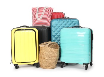 Photo of Many colorful suitcases and beach bags isolated on white