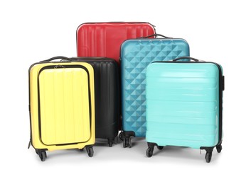 Photo of Many closed colorful suitcases isolated on white