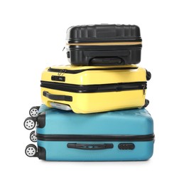 Photo of Stack of colorful suitcases isolated on white