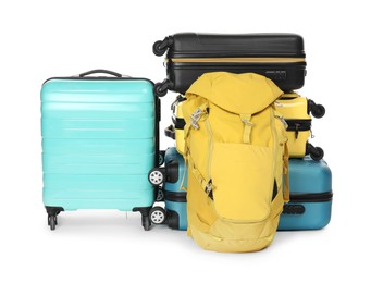 Photo of Many colorful suitcases and backpack isolated on white