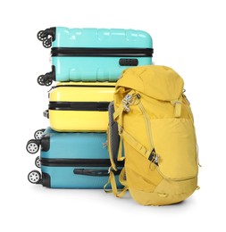 Photo of Stack of colorful suitcases and backpack isolated on white