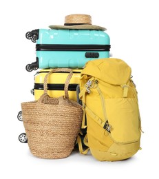 Photo of Many colorful suitcases, backpack, beach bag and straw hat isolated on white