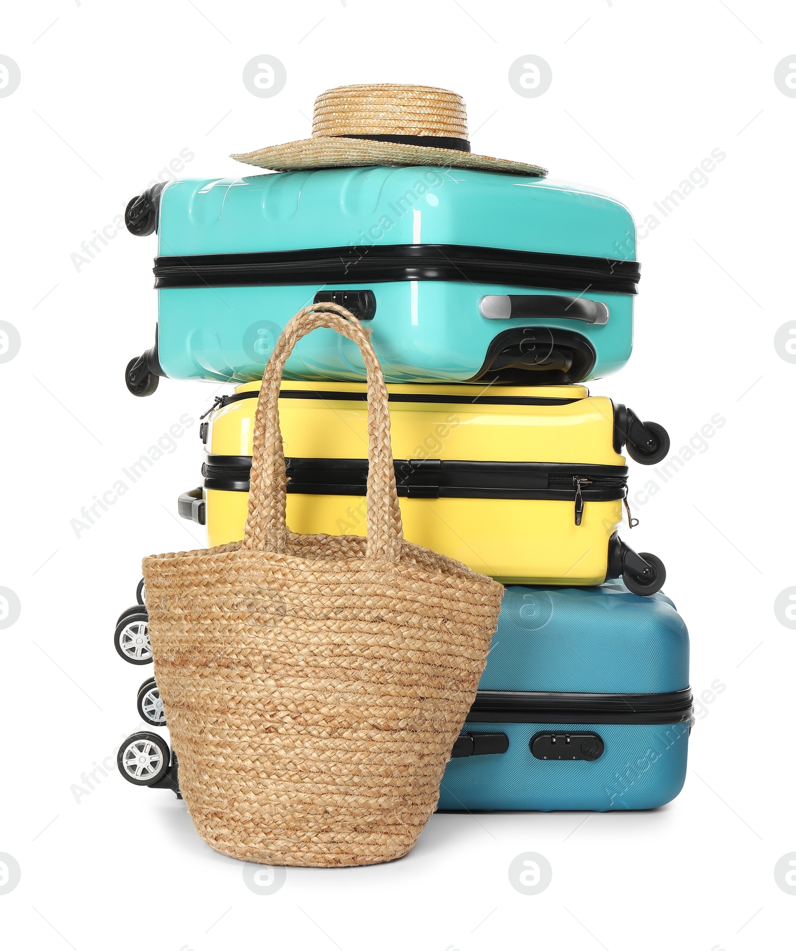 Photo of Many colorful suitcases, beach bag and straw hat isolated on white