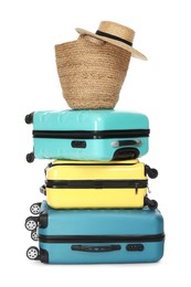 Photo of Many colorful suitcases, beach bag and straw hat isolated on white