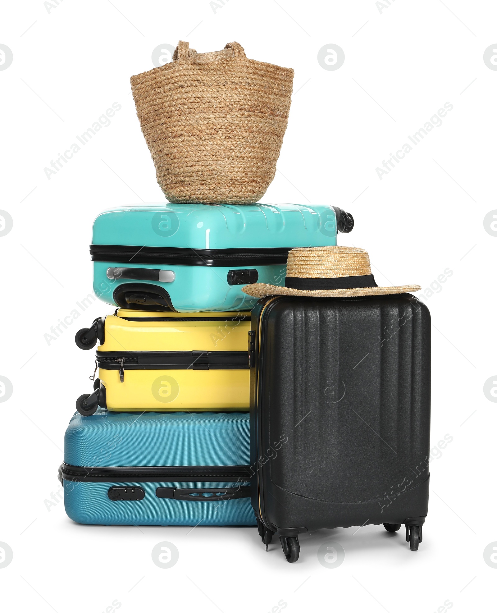 Photo of Many colorful suitcases, beach bag and straw hat isolated on white