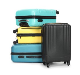 Photo of Stack of colorful suitcases isolated on white