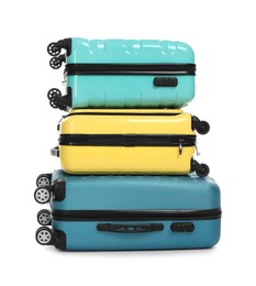 Photo of Stack of colorful suitcases isolated on white