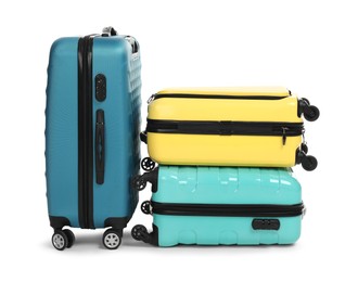 Photo of Many closed colorful suitcases isolated on white