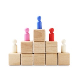 Photo of Human figures on wooden blocks, blue one on top against white background. Competition concept