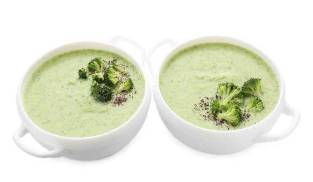 Photo of Delicious broccoli cream soup in bowls isolated on white