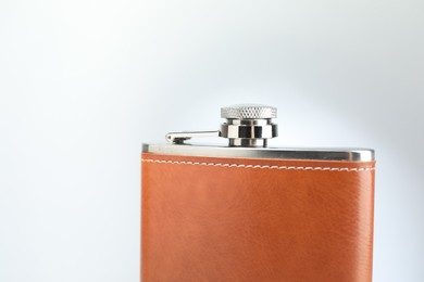 Photo of Hip flask on white background, closeup. Space for text