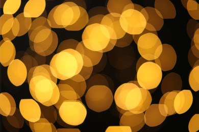 Photo of Blurred view of golden lights on dark background. Bokeh effect