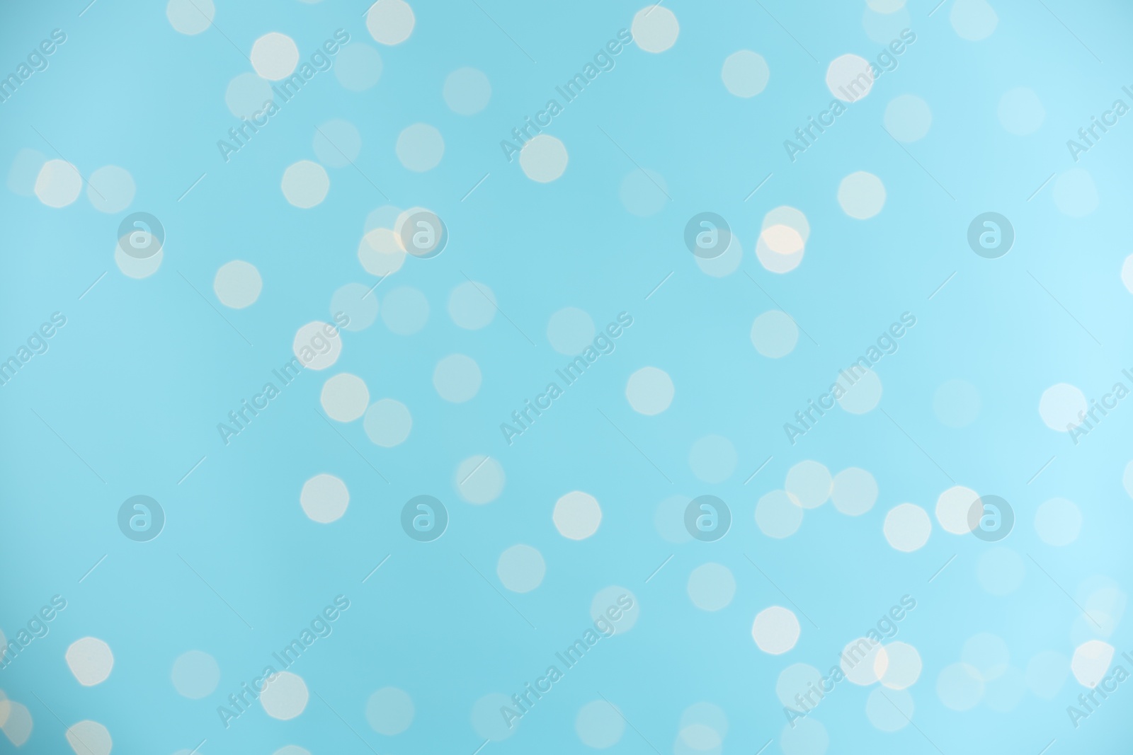 Photo of Light blue background with blurred lights, bokeh effect