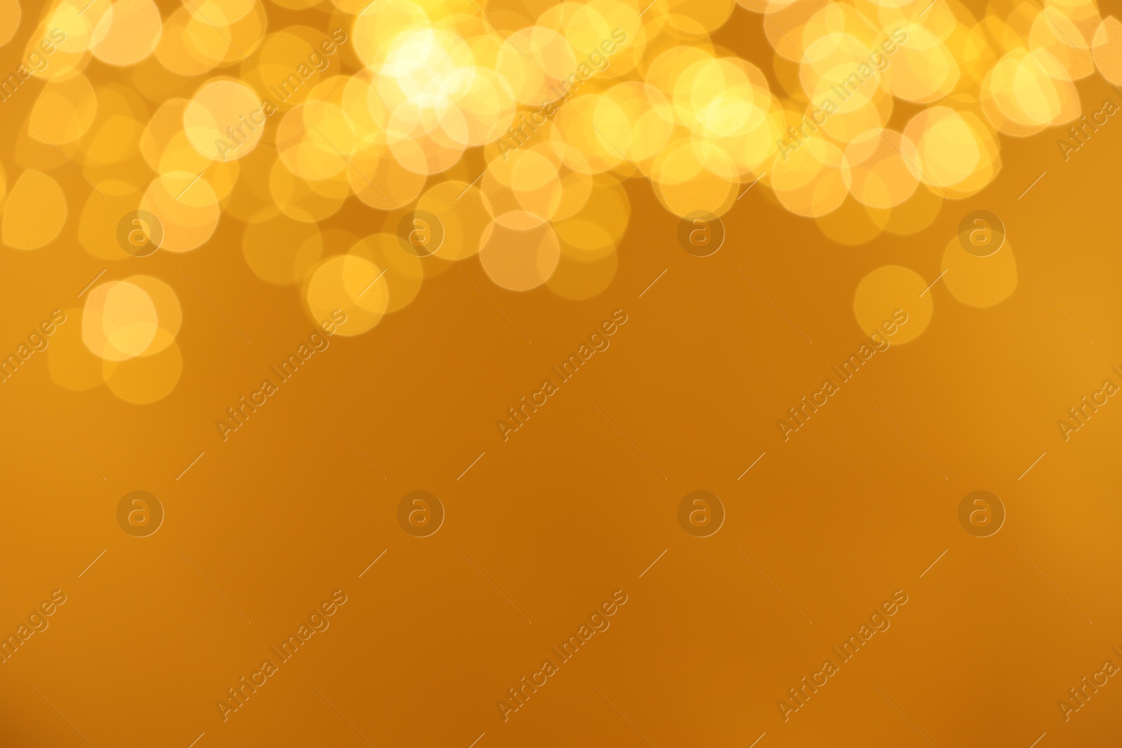 Photo of Golden background with blurred lights, bokeh effect