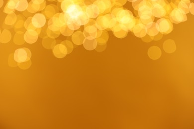 Photo of Golden background with blurred lights, bokeh effect