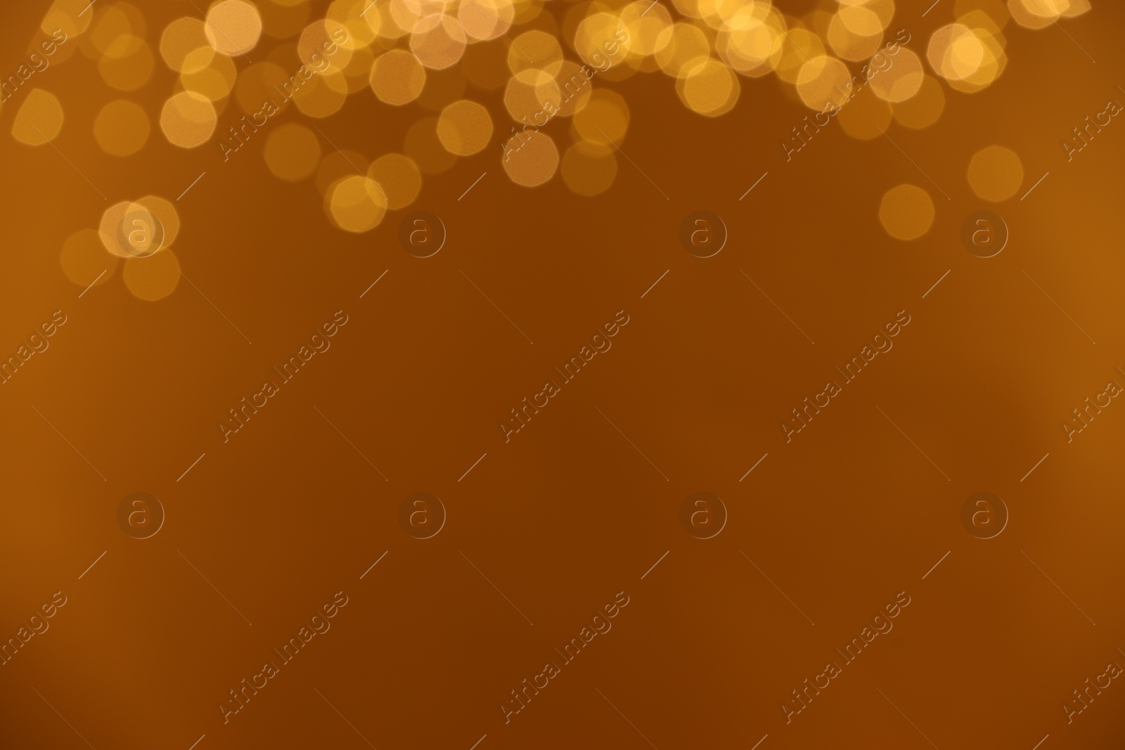 Photo of Golden background with blurred lights, bokeh effect