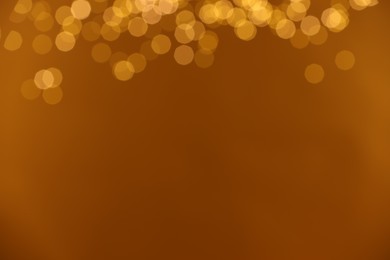 Photo of Golden background with blurred lights, bokeh effect