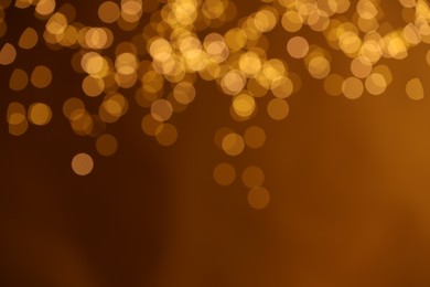 Photo of Golden background with blurred lights, bokeh effect