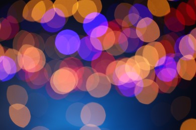 Photo of Blurred view of colorful lights on dark blue background, bokeh effect