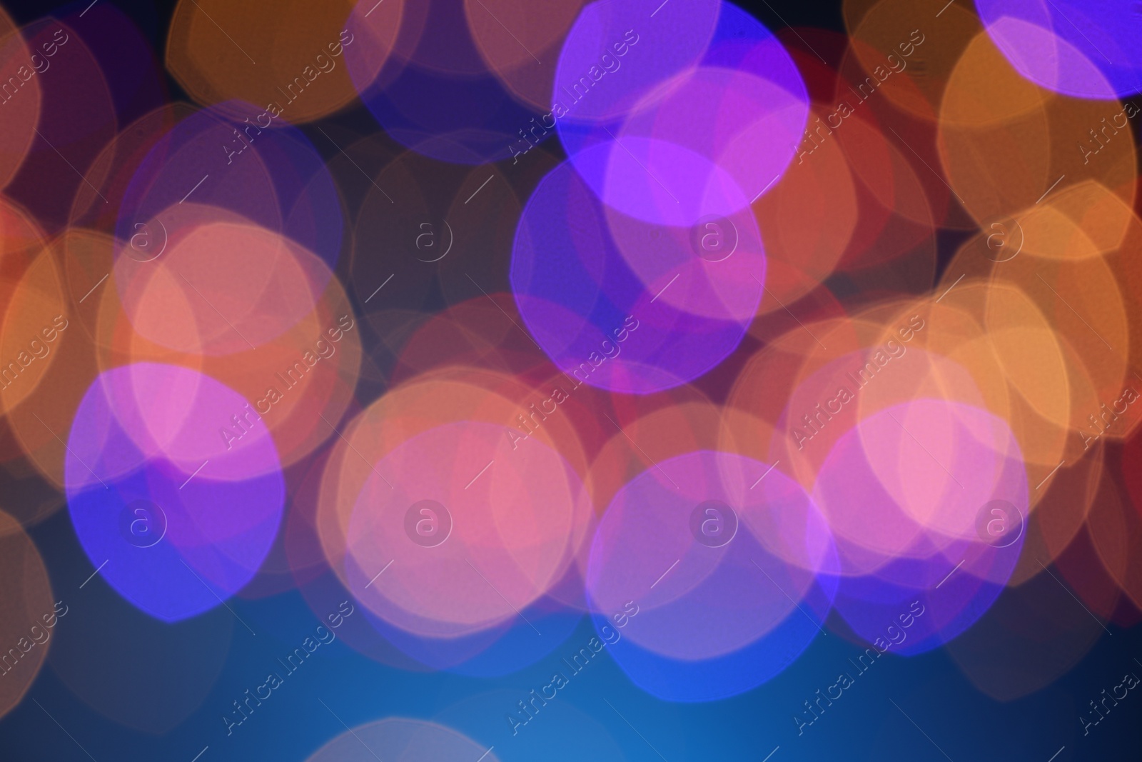 Photo of Blurred view of colorful lights on dark blue background, bokeh effect