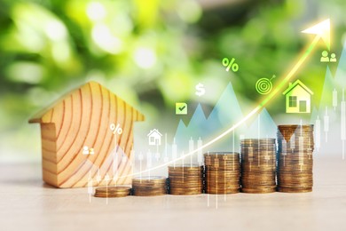 Image of Real estate market. Stacked coins and house model on table. Graphic, arrow and icons visualizing interest rate rise