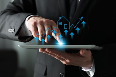 Image of Real estate market. Man using computer tablet, closeup. Graphic, arrows and illustration of house visualizing interest rate rise