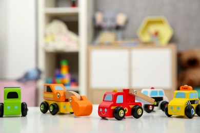 Photo of Many car toys on white table in kids room