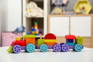 Photo of Colorful train toy on white table in kids room