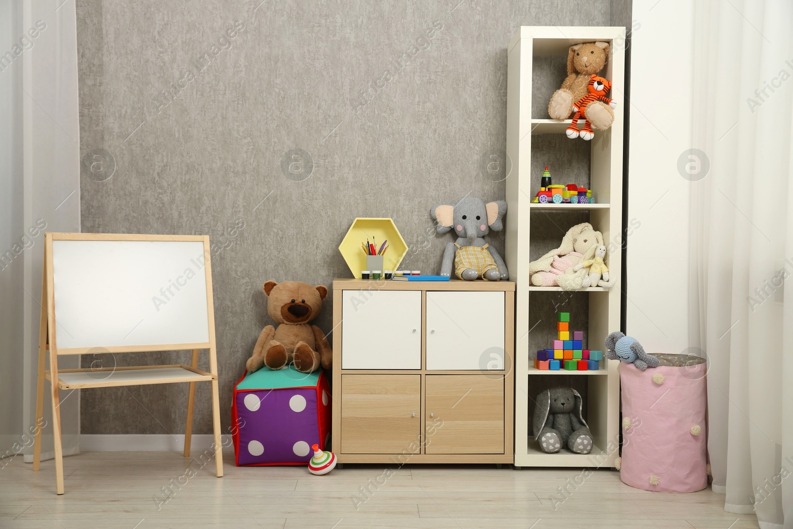 Photo of Beautiful kid's room interior with toys and stylish furniture