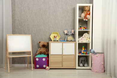 Photo of Beautiful kid's room interior with toys and stylish furniture