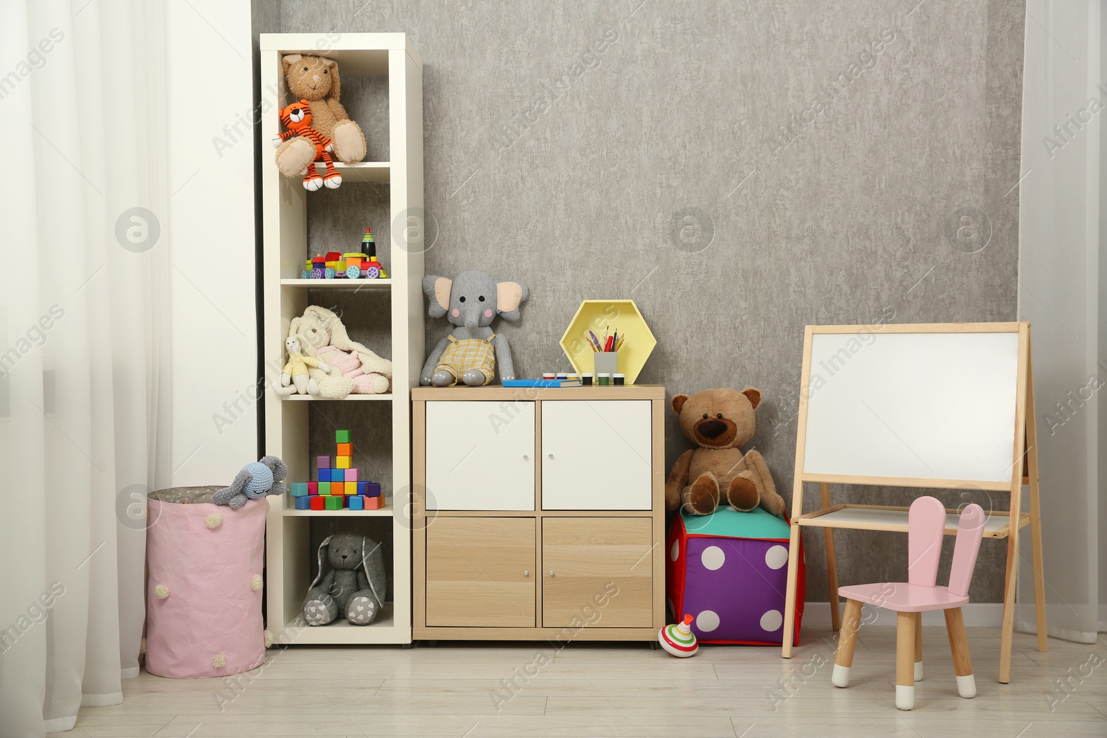 Photo of Beautiful kid's room interior with toys and stylish furniture