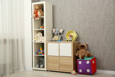 Photo of Beautiful kid's room interior with toys and stylish furniture