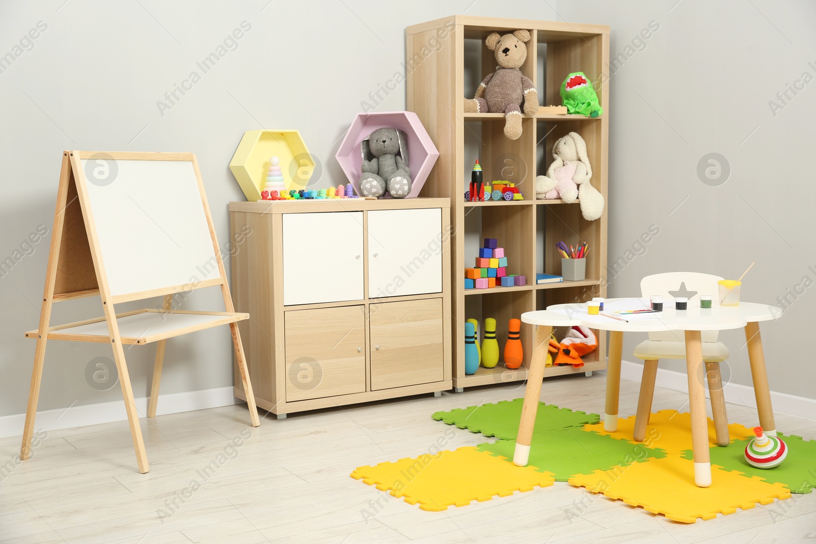 Photo of Beautiful kid's room interior with toys and stylish furniture