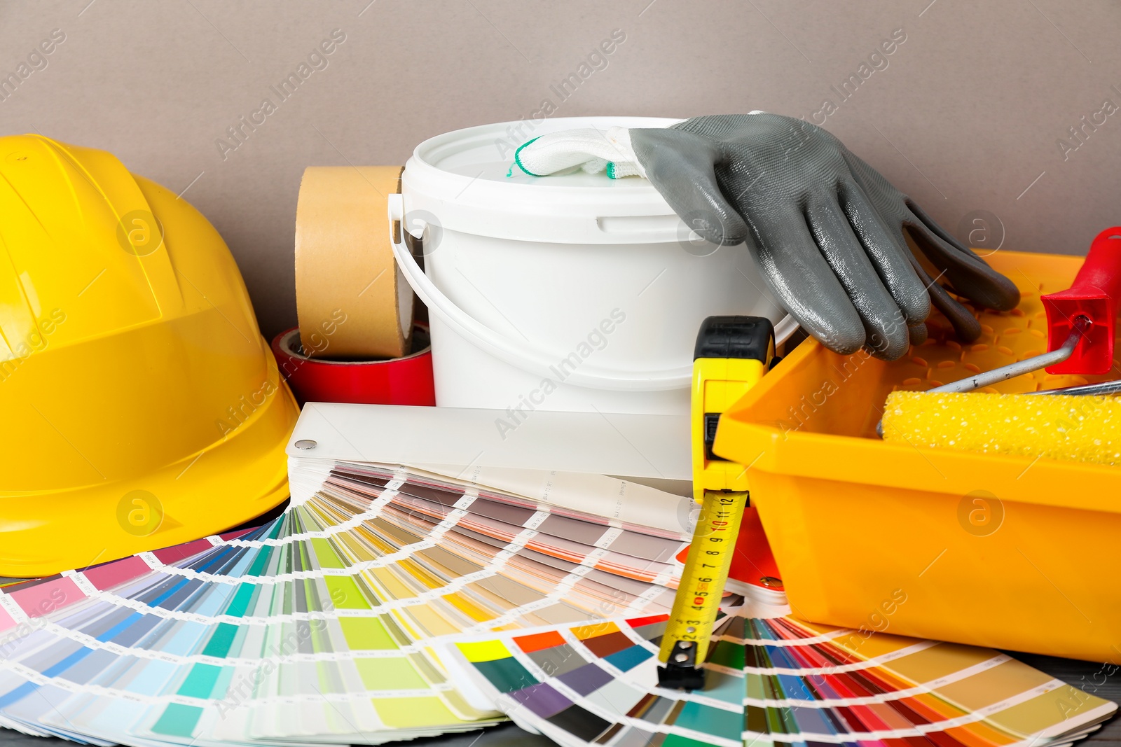 Photo of Different painter's tools on table. Decorating and design