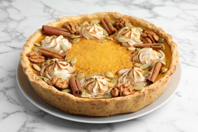 Photo of Tasty homemade pumpkin pie on white marble table, closeup