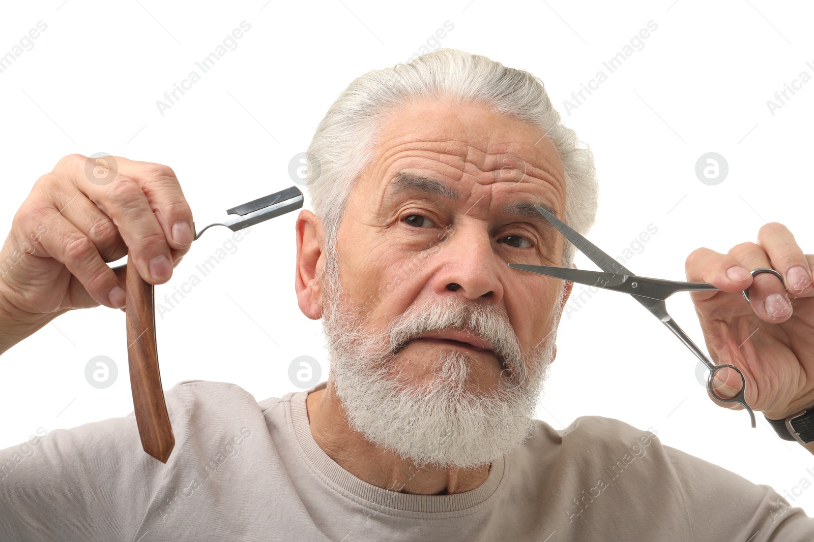 Photo of Bearded senior man holding blade and scissors on white background