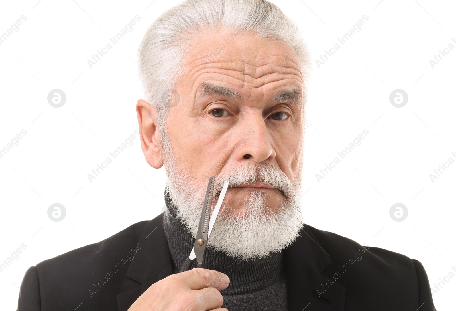 Photo of Senior man trimming beard with scissors on white background