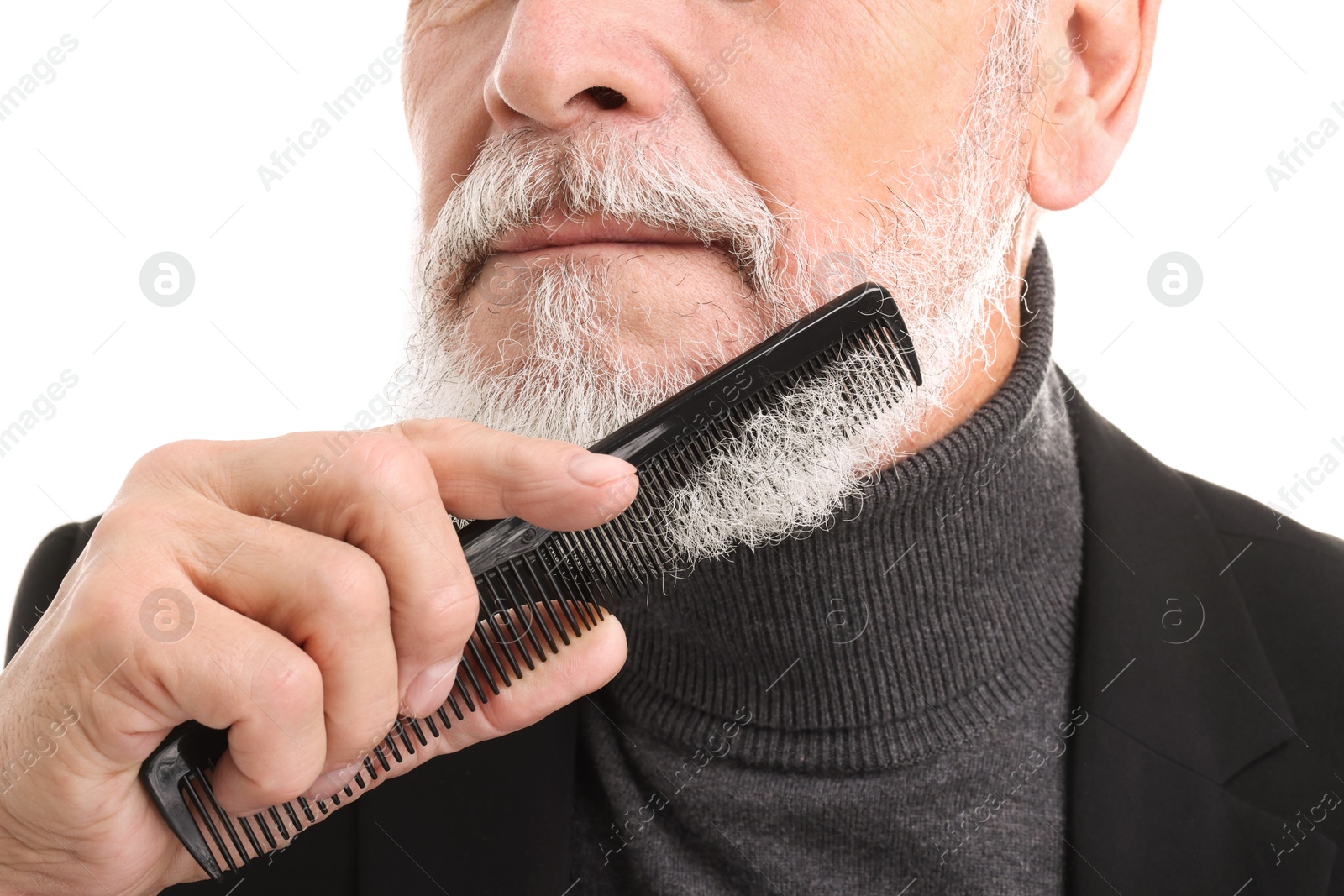 Photo of Senior man combing beard on white background, closeup