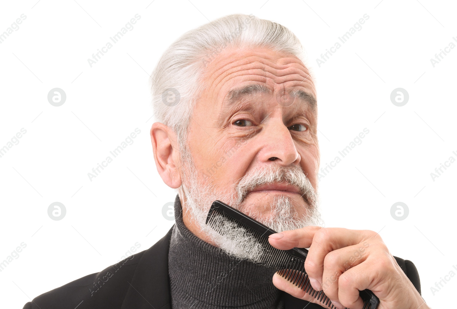 Photo of Senior man combing beard on white background