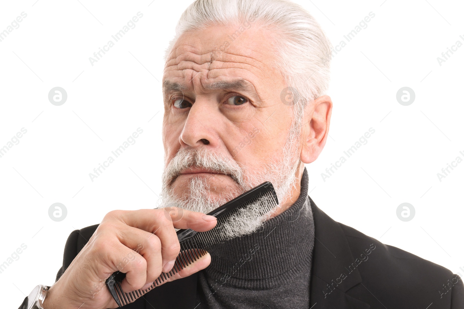 Photo of Senior man combing beard on white background