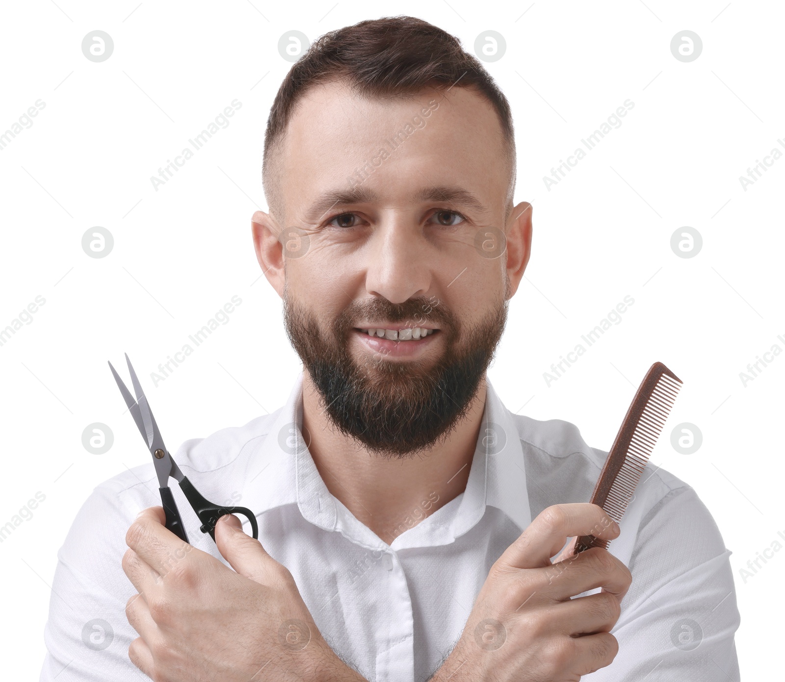 Photo of Bearded man holding comb and scissors on white background