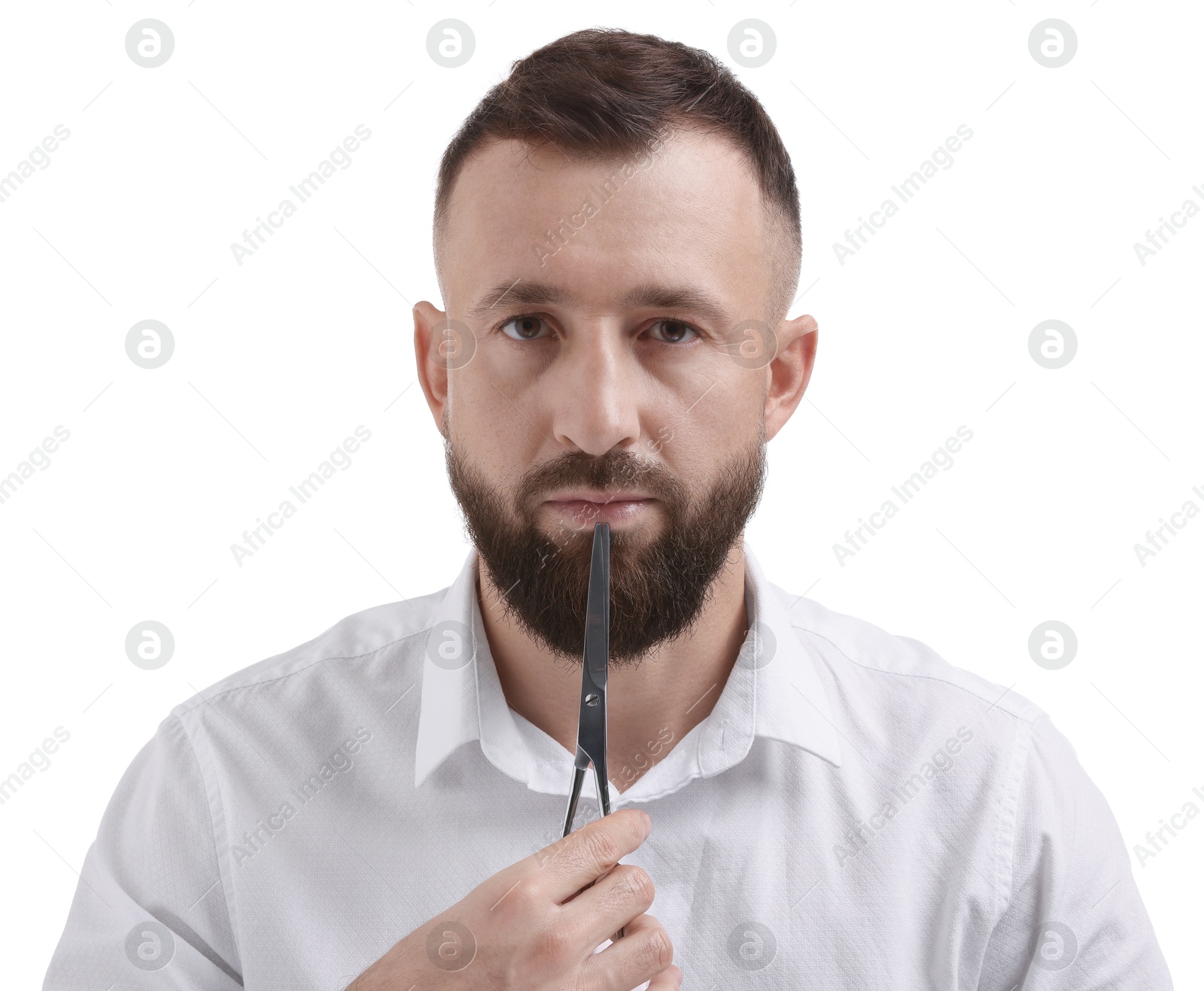 Photo of Bearded man holding scissors on white background